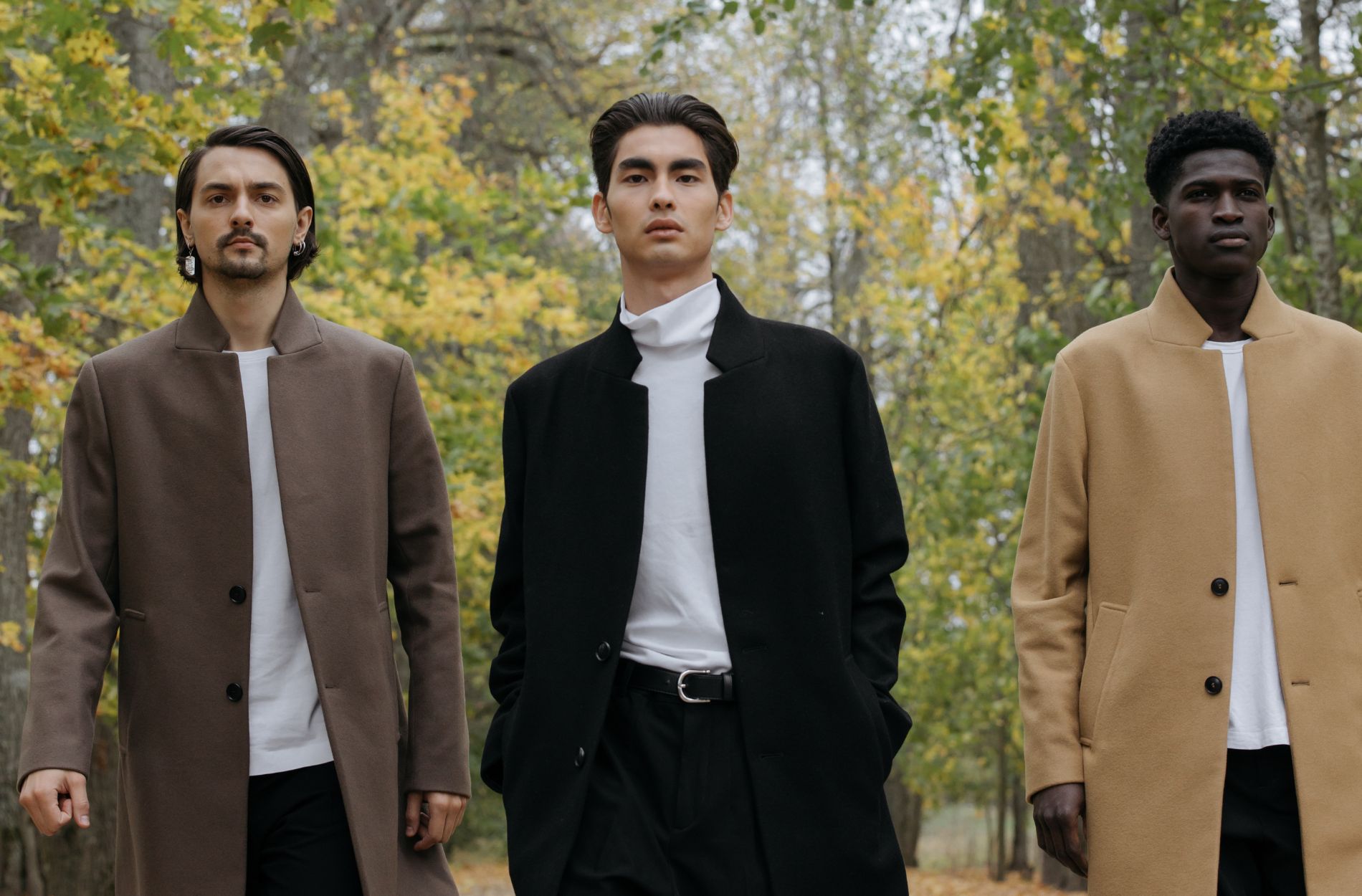 An image of three men wearing overcoats outdoors - keep yours in pristine condition with these tips from Pearce Bespoke Greater Syracuse.