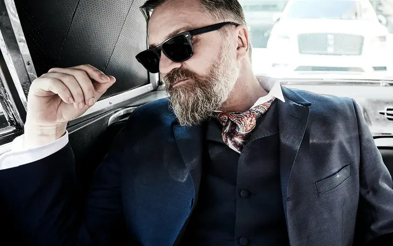 A shot of a man in a car wearing a Pearce Bespoke custom suit.
