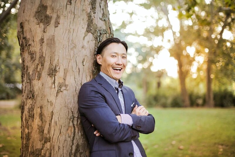 A man in a bespoke suit leaning against a suit - Building a Sustainable and Eco-conscious Bespoke Suit Franchise with Pearce Bespoke 