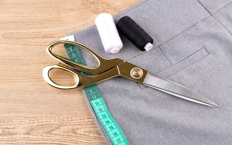 A pair of scissors and thread ready to be used for Pearce Bespoke custom fits.
