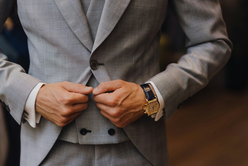 A man holding the lapels of his suit - Learn about custom clothing fit tips for Syracuse, NY