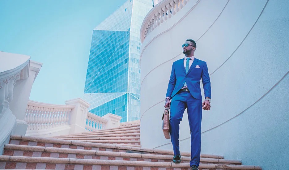 A professional man in a blue suit out side of an office building