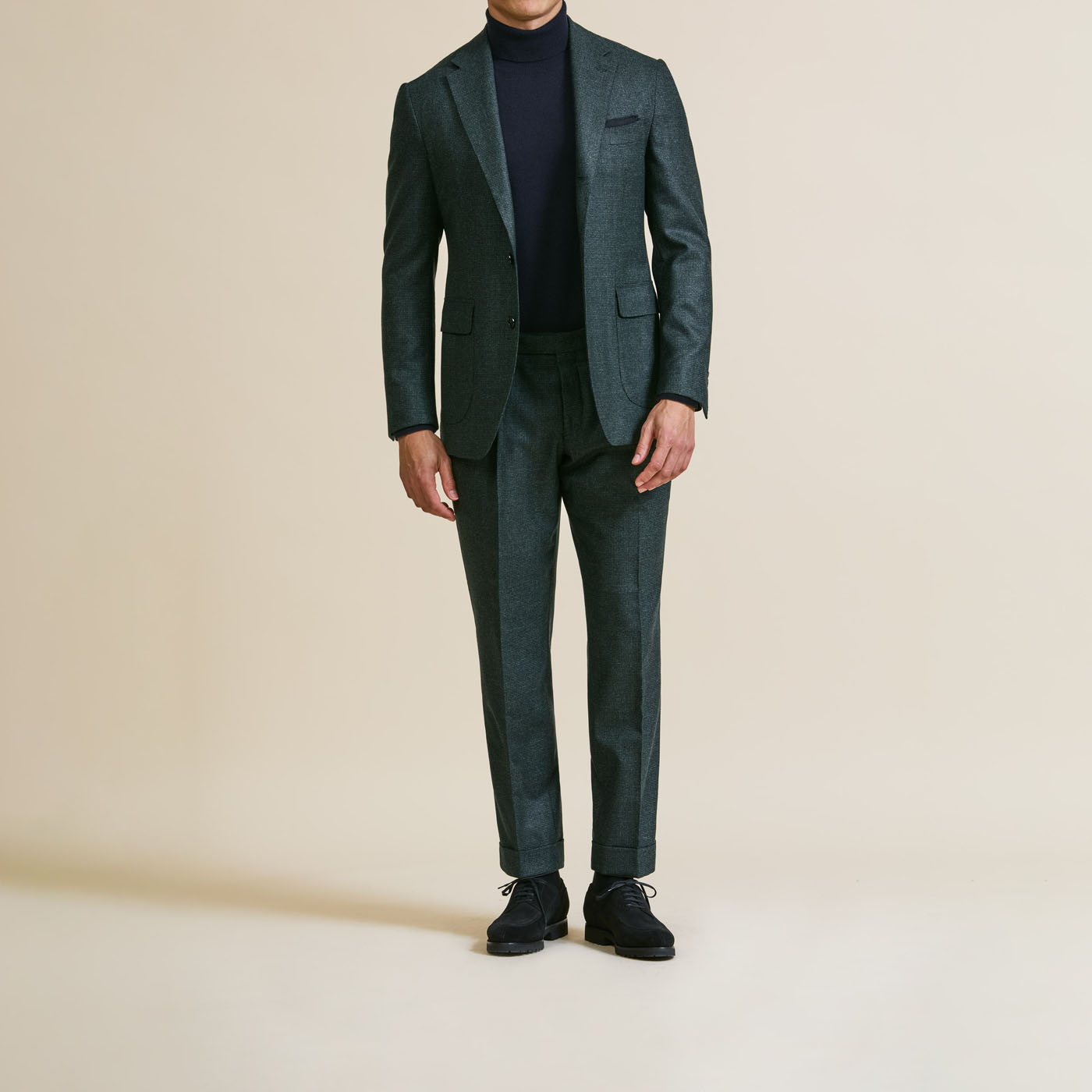A sleek dark green suit customized by Pearce Bespoke Greater Syracuse.
