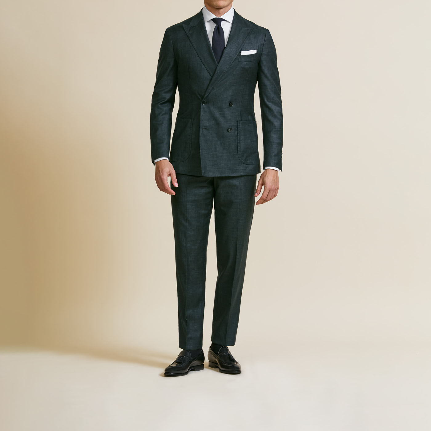 An elegant double-breasted suit from Pearce Bespoke Greater Syracuse styled by a male model.