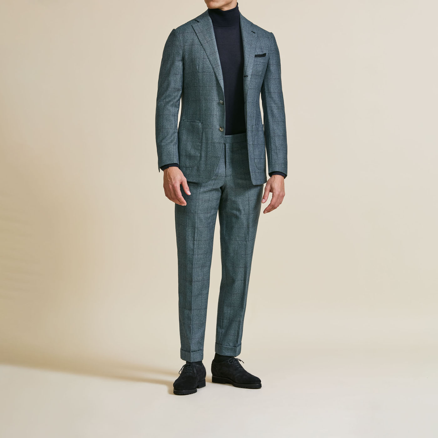 A Pearce Bespoke Greater Syracuse custom suit on a male model with a black turtleneck.