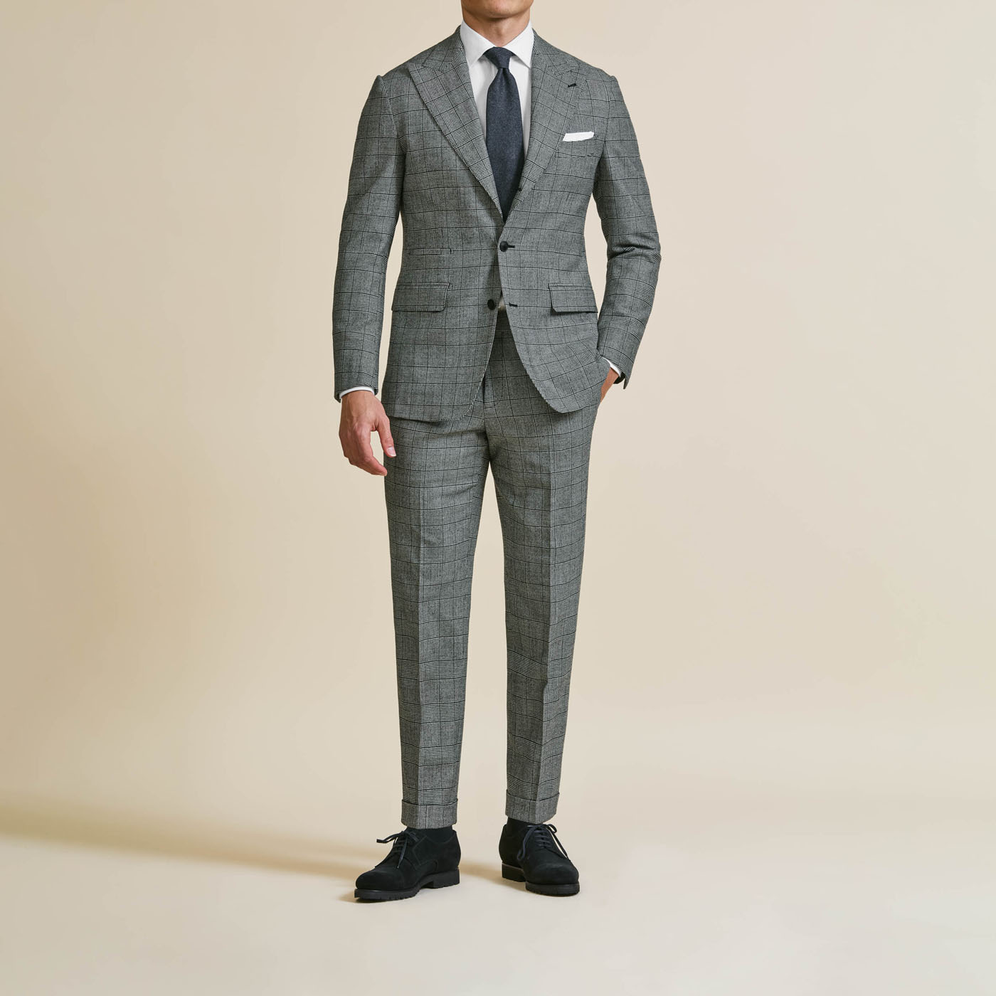 A stylish gray Pearce Bespoke Greater Syracuse custom suit styled by a male model.