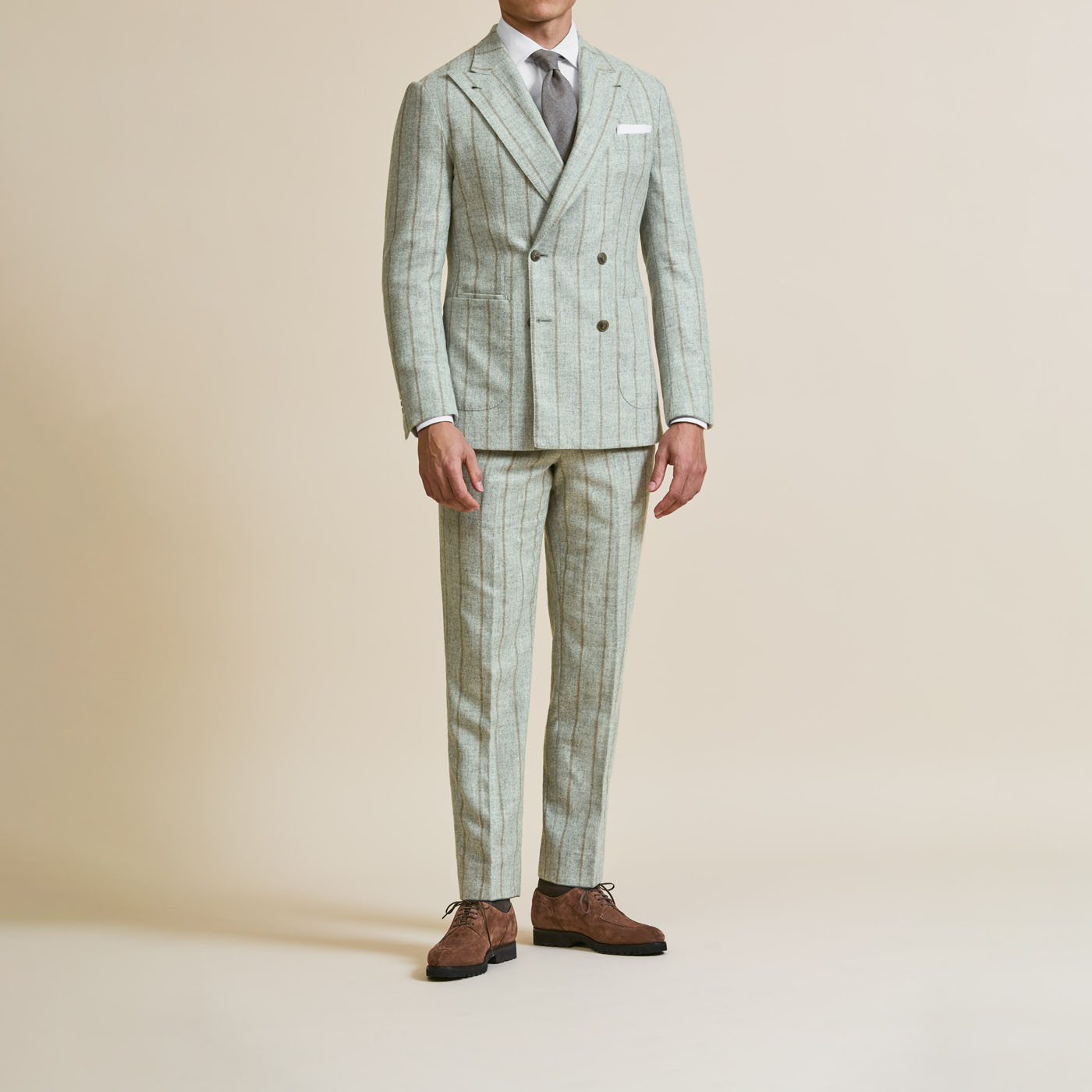 A light-green Pearce Bespoke Greater Syracuse custom suit on a male model.
