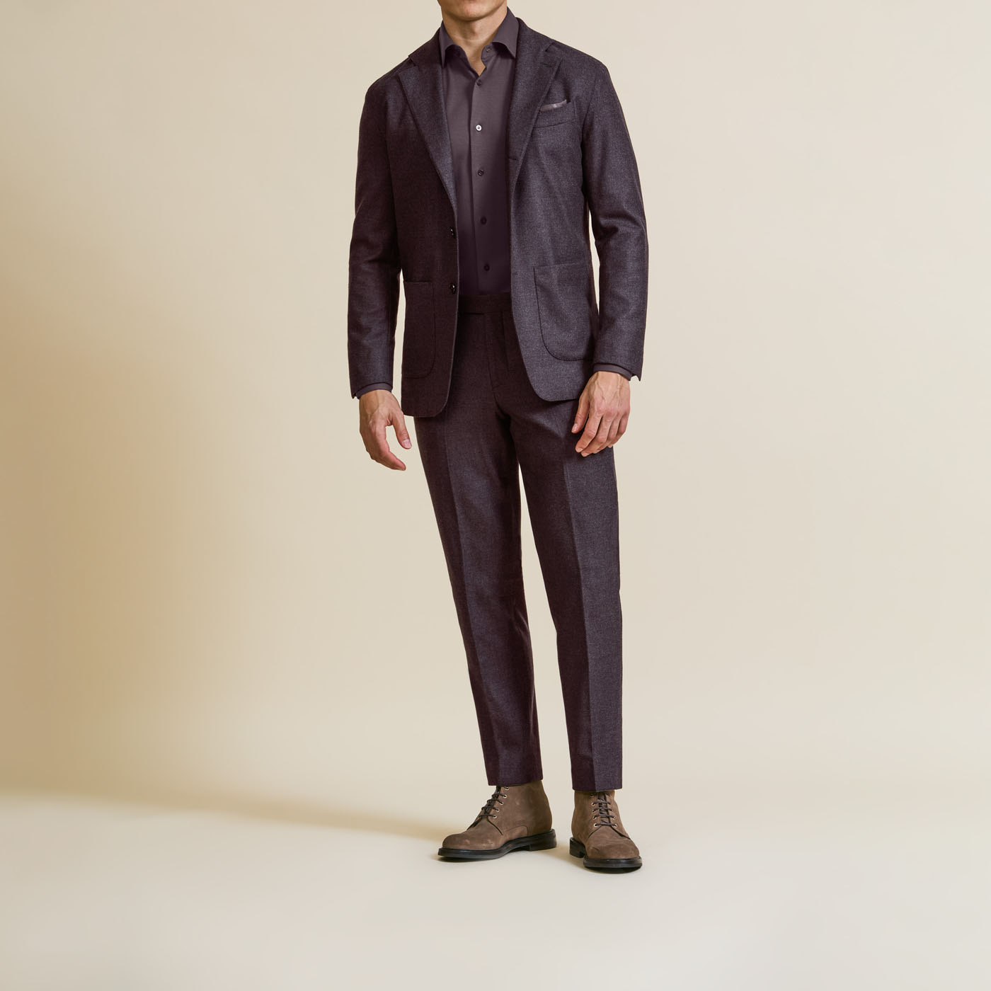 A sleek, casual tailored suit from Pearce Bespoke Greater Syracuse, styled with a plum-colored shirt.