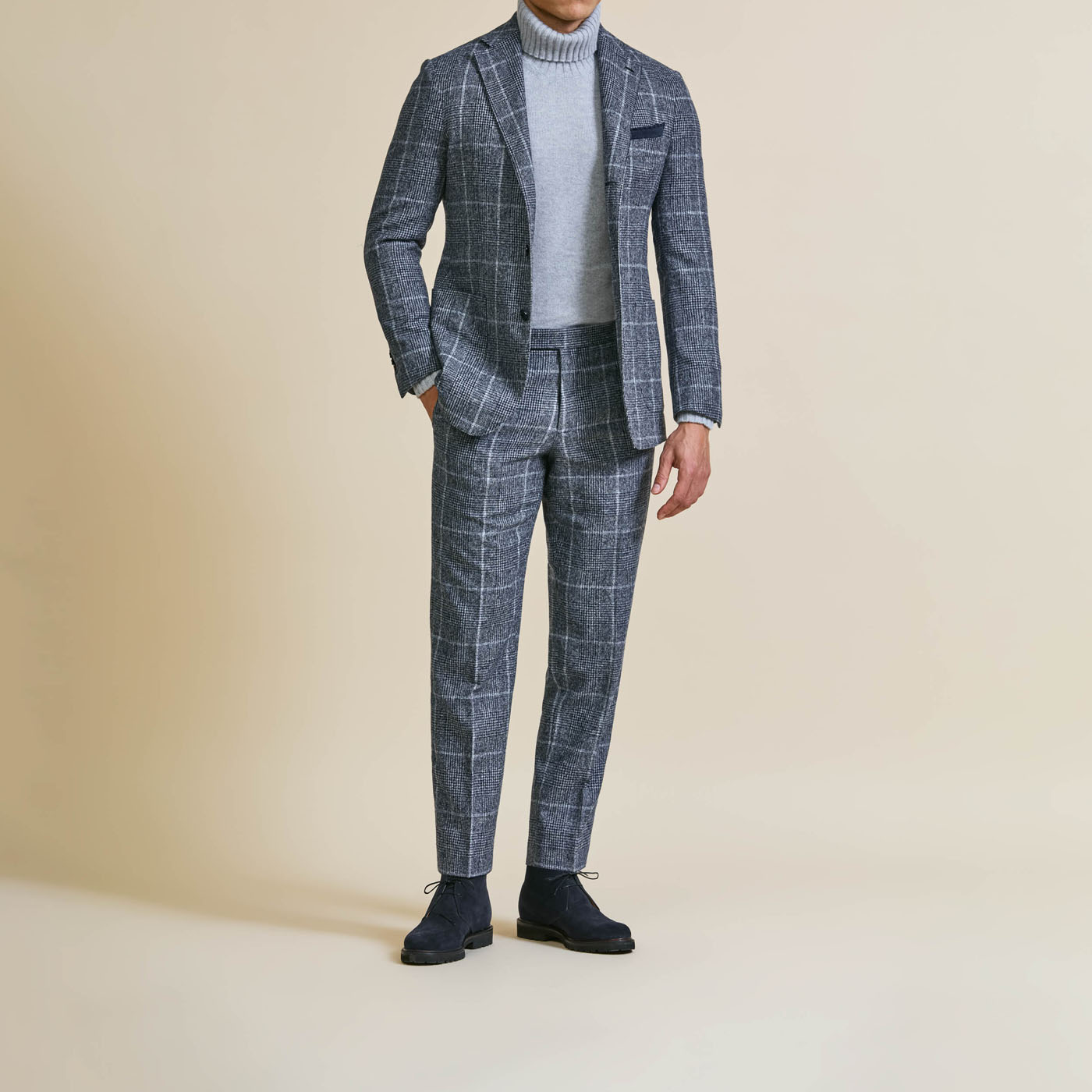 A Pearce Bespoke Greater Syracuse custom suit with light plaid on a male model.