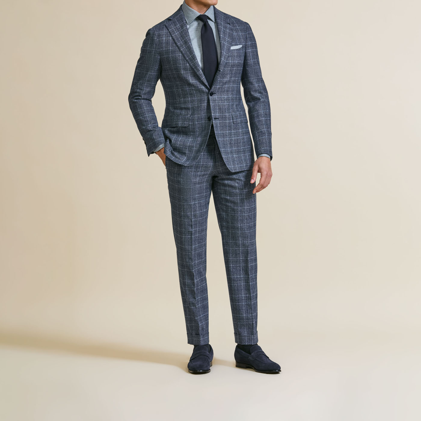 A professionally-styled gray plaid Pearce Bespoke Greater Syracuse suit.