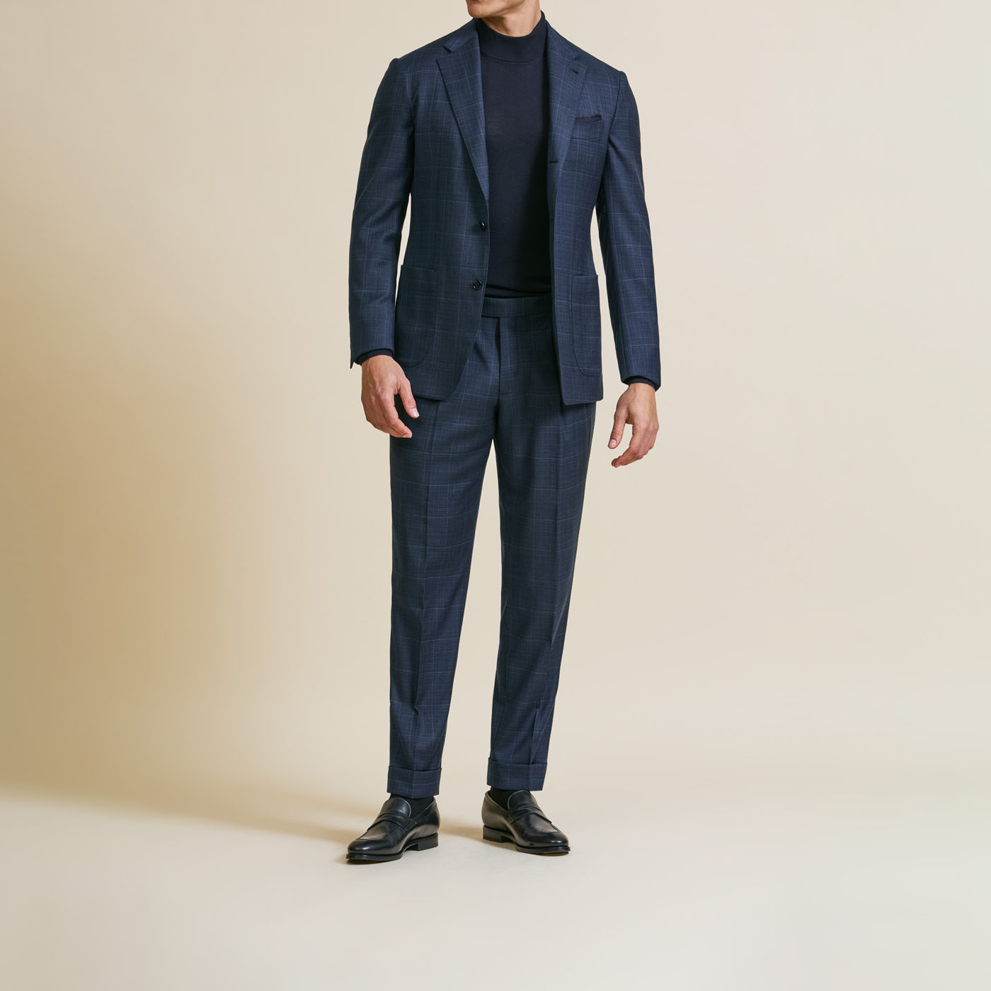 A model casually styling a classic customized Pearce Bespoke Greater Syracuse suit with a dark shirt underneath.