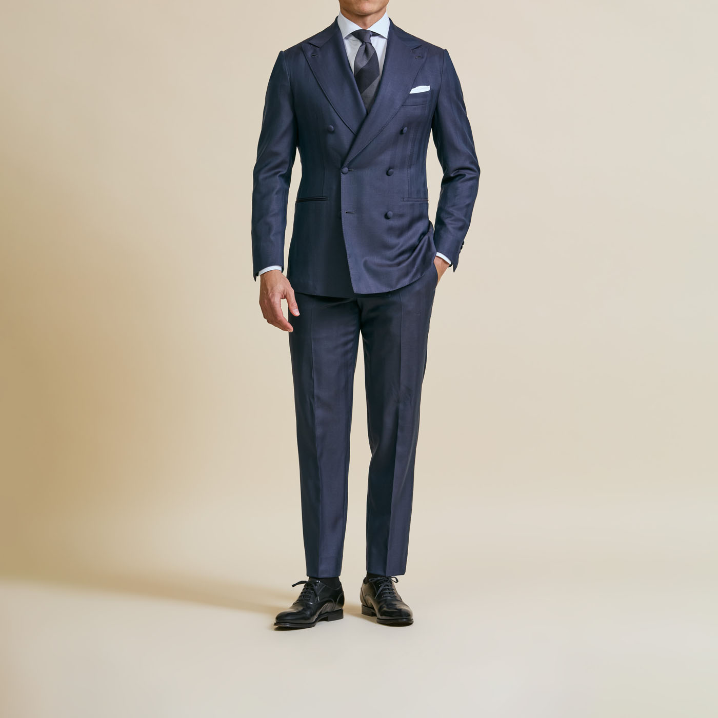 A model styling a classic, buttoned-up customized Pearce Bespoke Greater Syracuse suit.
