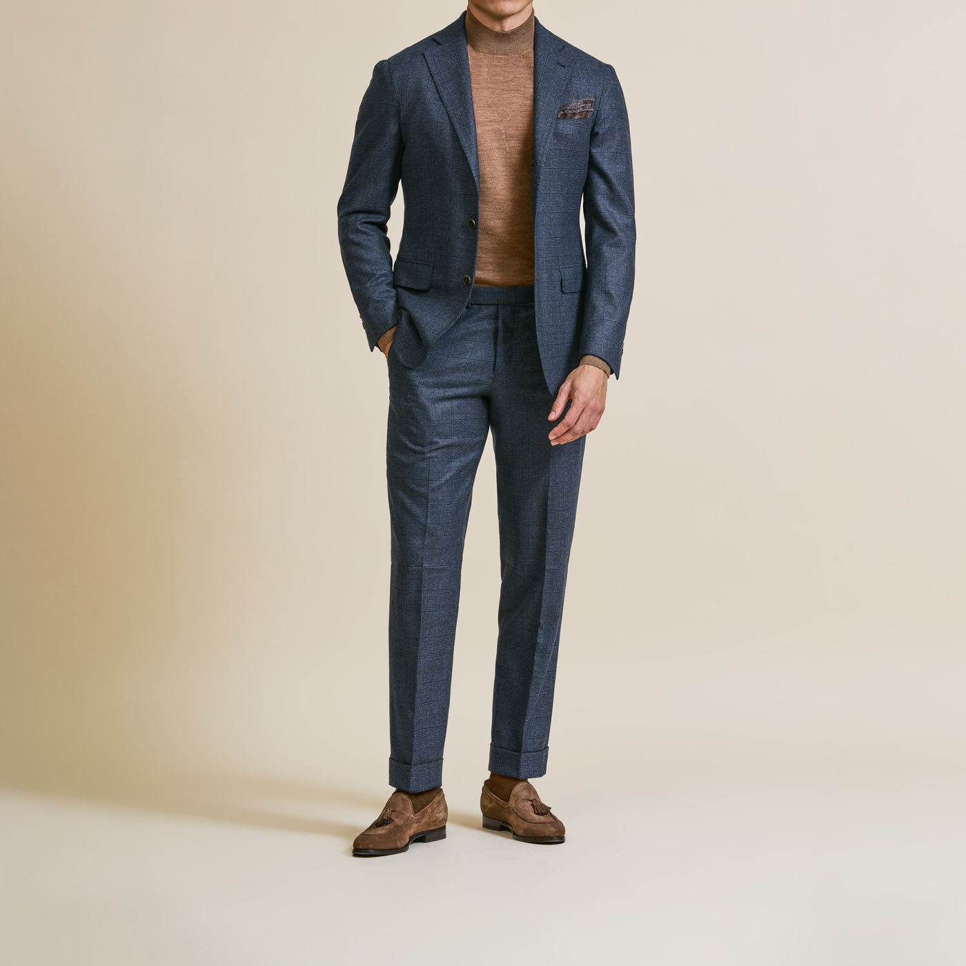 A dark-colored Pearce Bespoke Greater Syracuse tailored suit styled with a brown casual shirt.