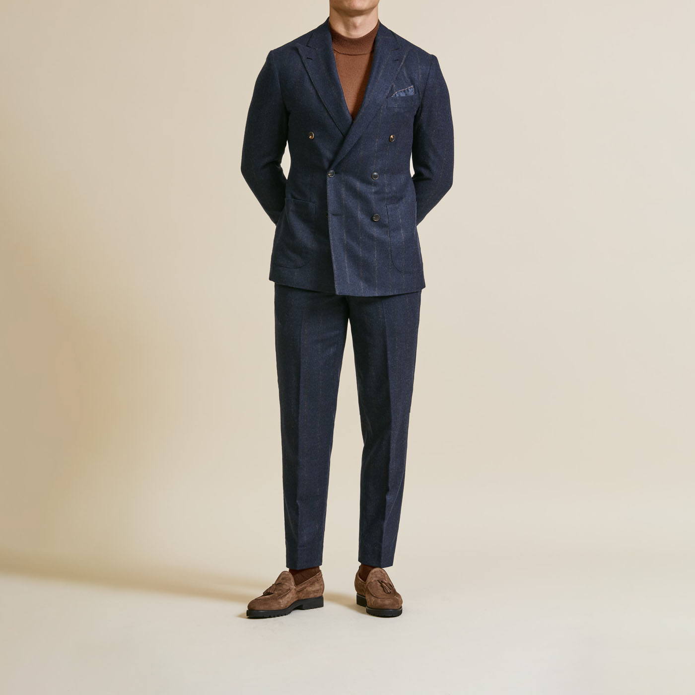 A buttoned-up Pearce Bespoke Greater Syracuse tailored suit styled with a brown casual shirt.