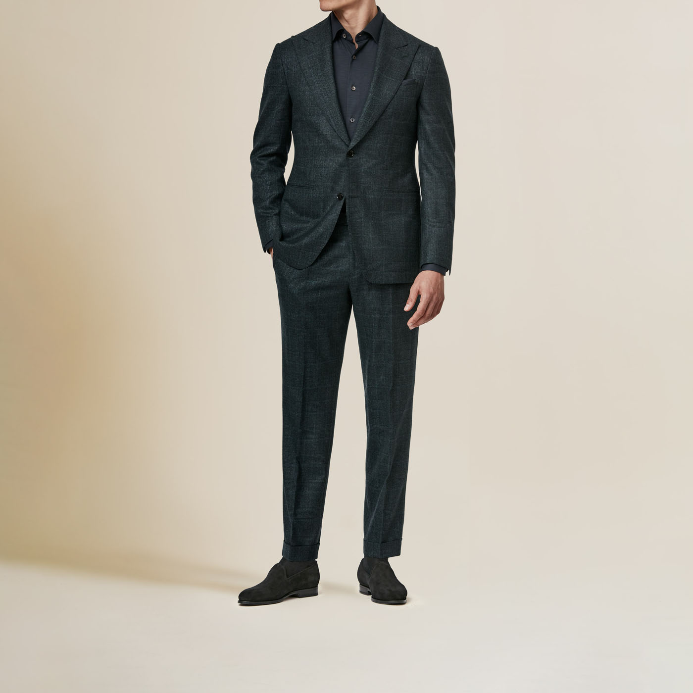 A model wearing an entirely black outfit, including a Pearce Bespoke Greater Syracuse custom suit.