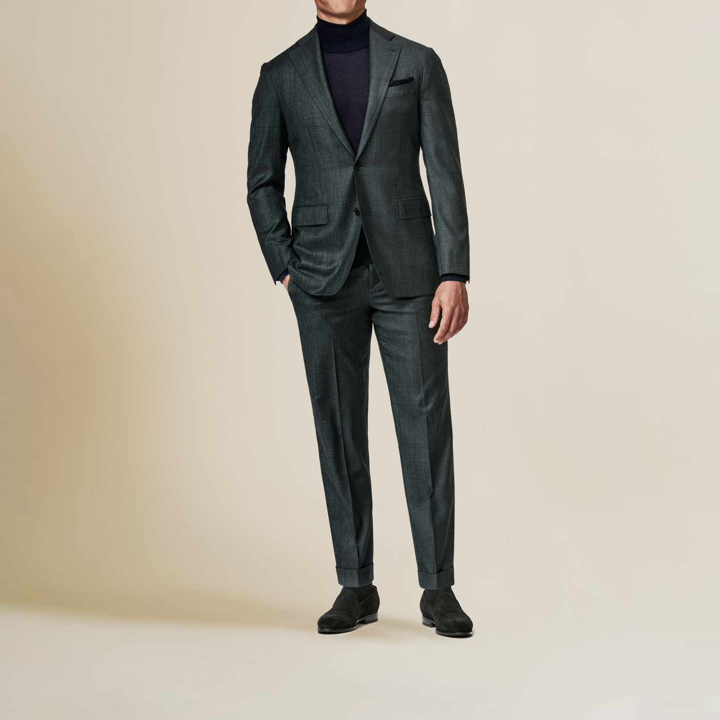A deep gray-green Pearce Bespoke Greater Syracuse custom suit on a male model.