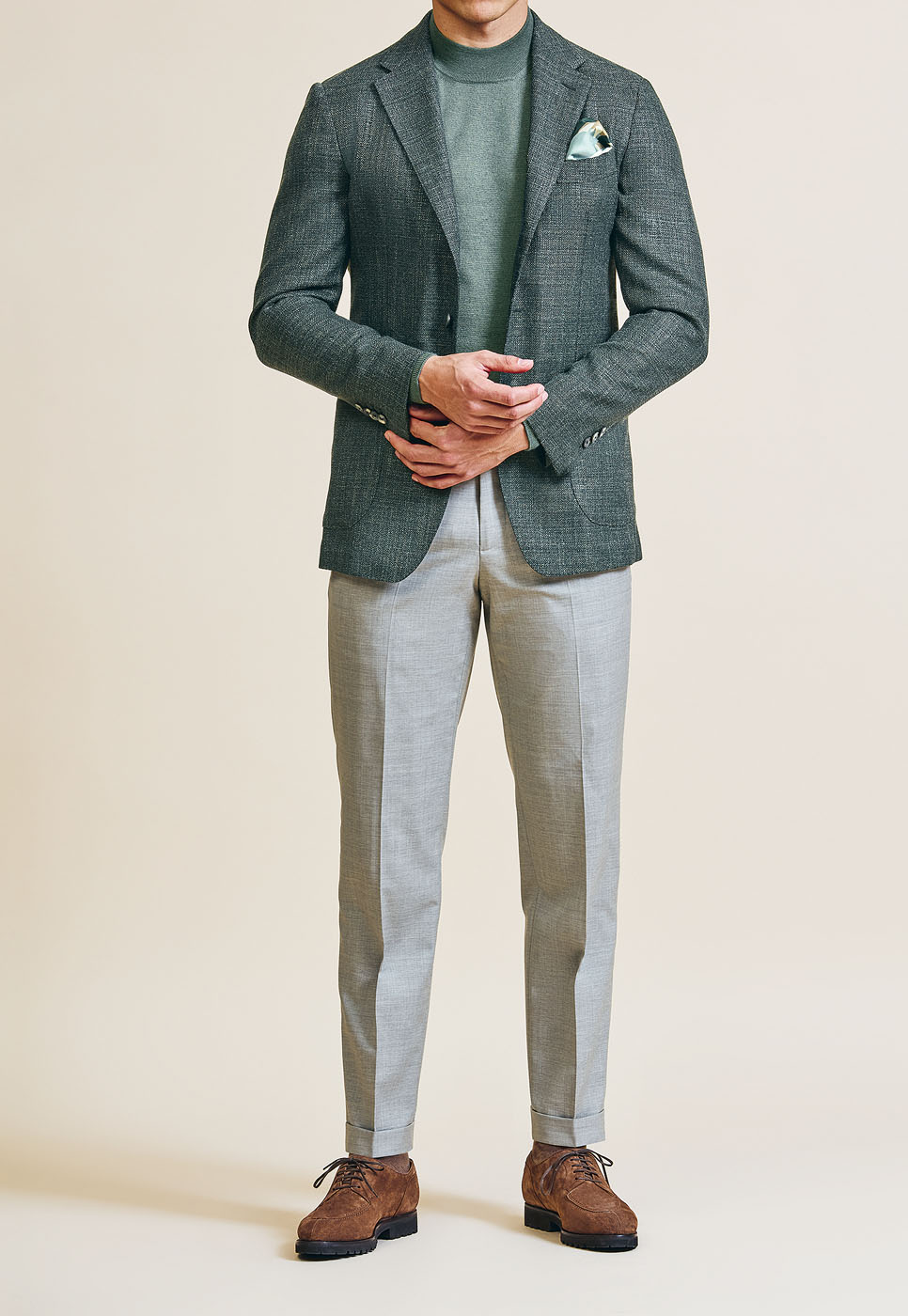 A male model styling a Pearce Bespoke Greater Syracuse custom light green coat.