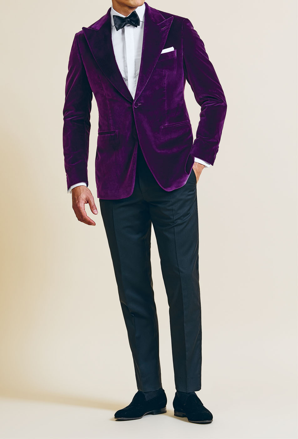 A male model styling a Pearce Bespoke Greater Syracuse custom tuxedo suit in a rich purple color.