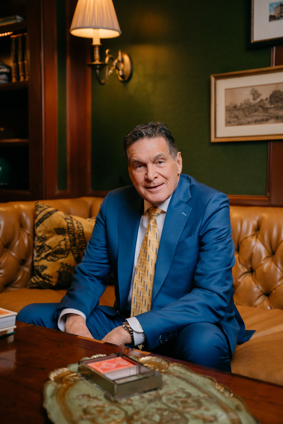 A professional man sitting down in a suit made by Pearce Bespoke - for executive suits, reach out today.