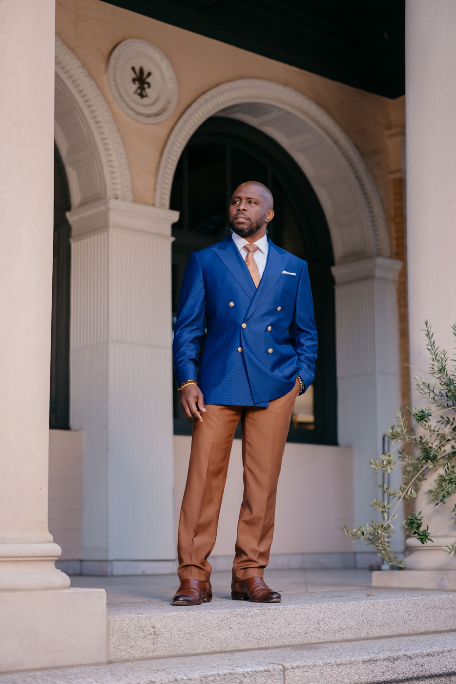 A man wearing a custom suit created by Pearce Bespoke clothiers outdoors in New Orleans, LA.