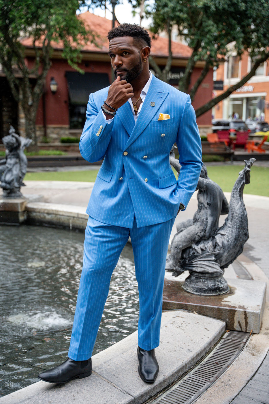 An image of a man in a custom blue suit.