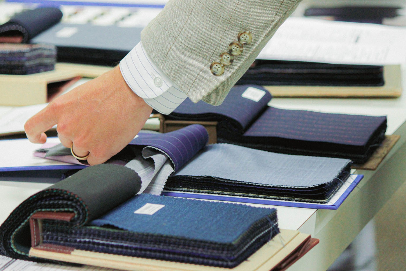 A person browsing through material options at Pearce Bespoke.