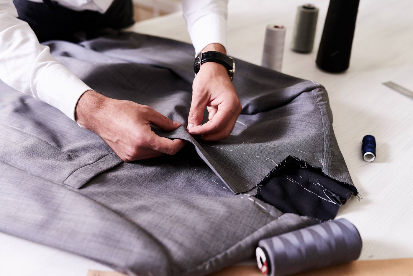 A close up of a Pearce Bespoke tailored suit being measured.