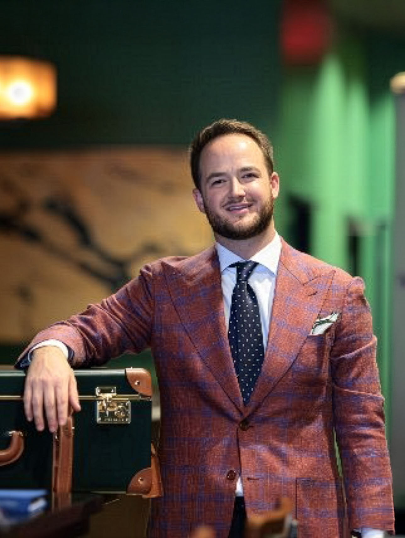 Owner and founder Nathan Pearce standing next to a custom suit in New Orleans, LA.