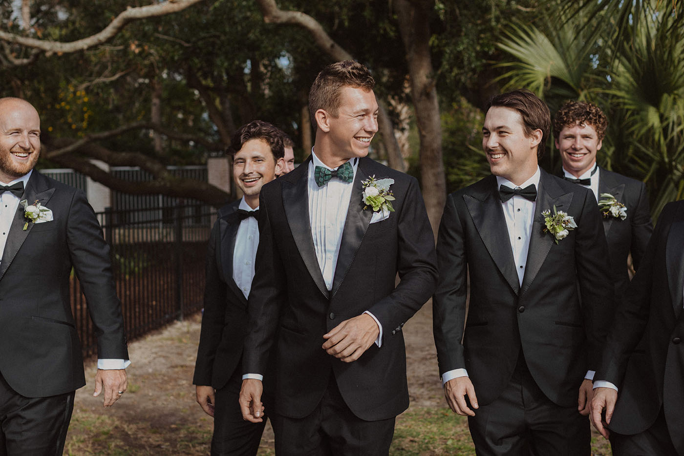 A groom laughing with his groomsman in New Orleans, LA.