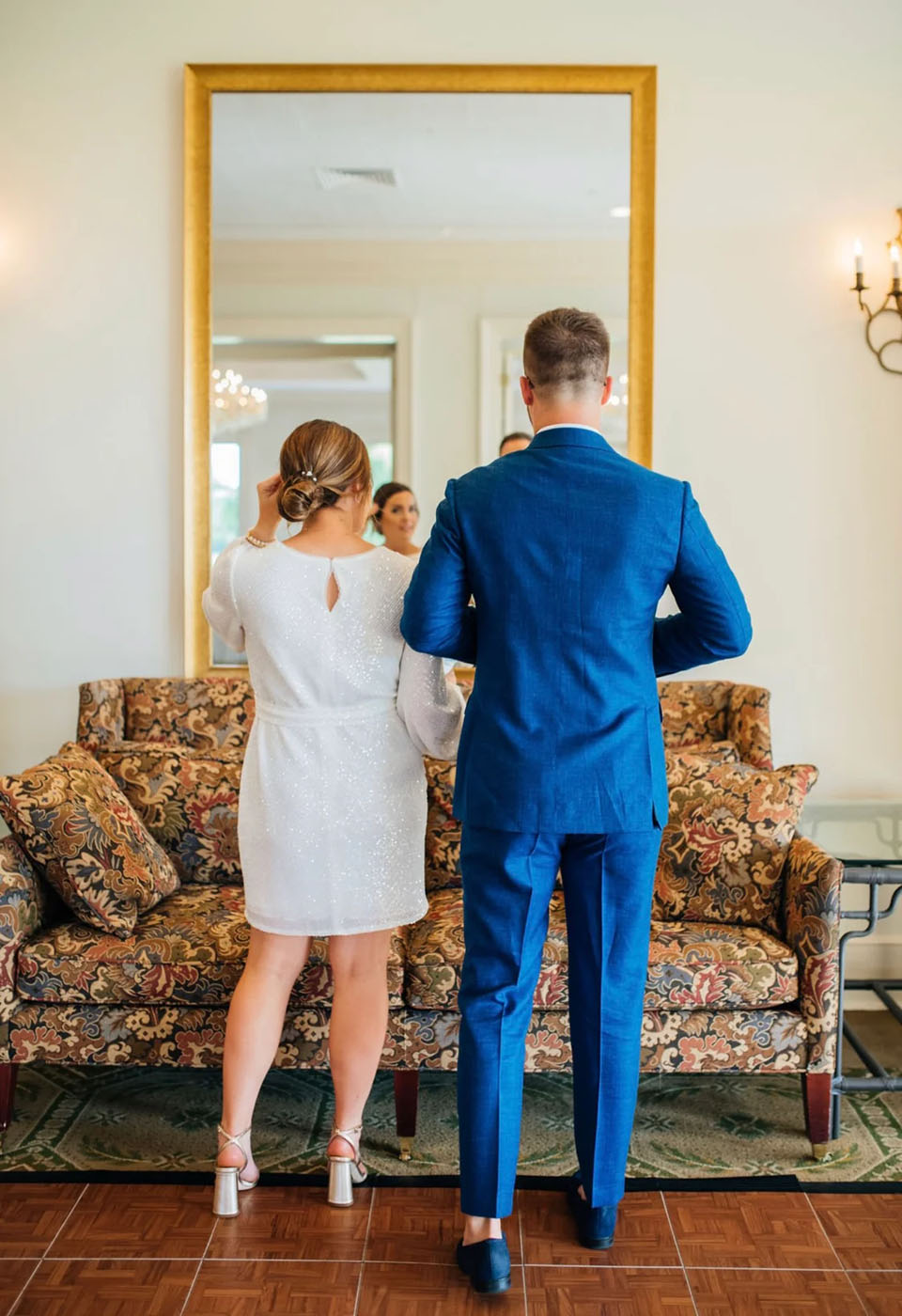 Bride and groom standing in front of a mirror on their wedding day, looking for wedding party ideas in Charlotte, NC, choose Pearce Bespoke.