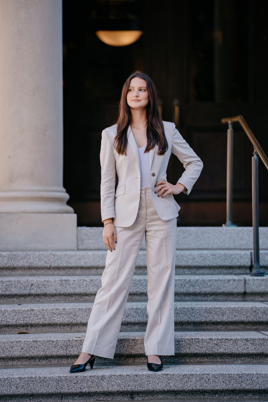 A woman in a custom beige real estate agent suit - call Pearce Bespoke to start designing yours. 